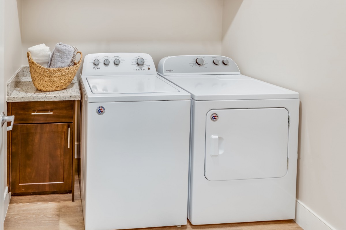 A laundry room featuring a washing machine and dryer side by side.