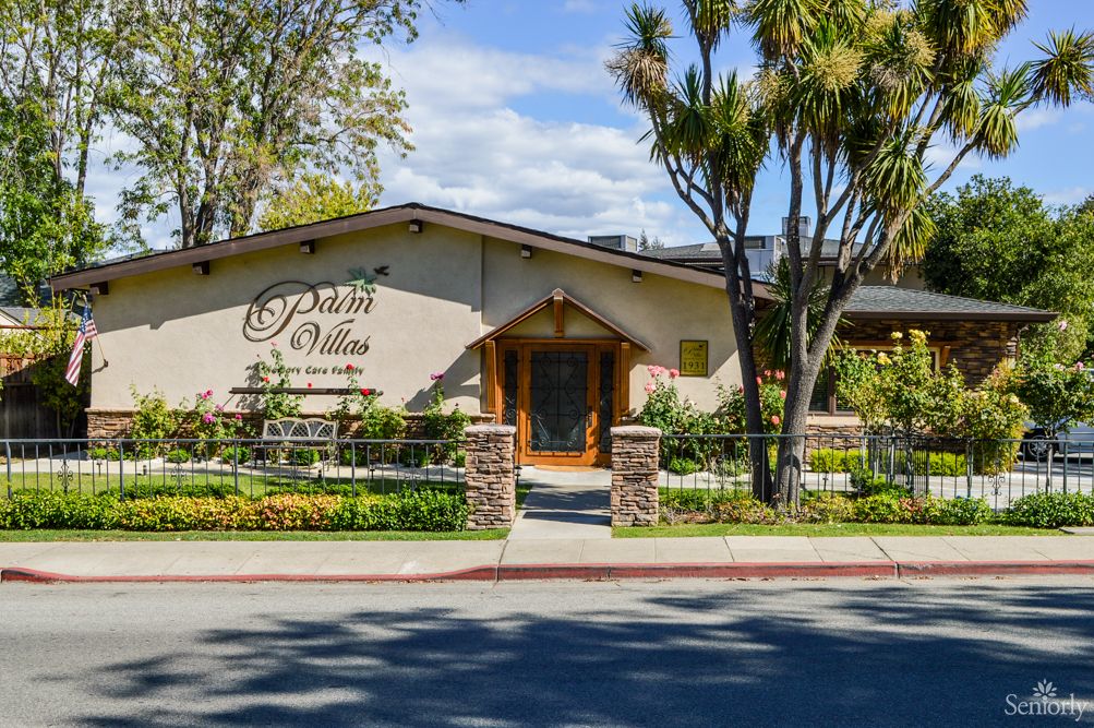 Exterior view of a restaurant surrounded by trees on a sunny day.