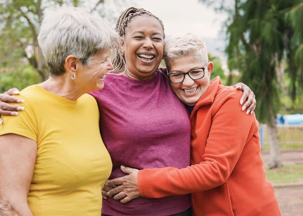 A group of friends enjoying a cheerful moment together outdoors.