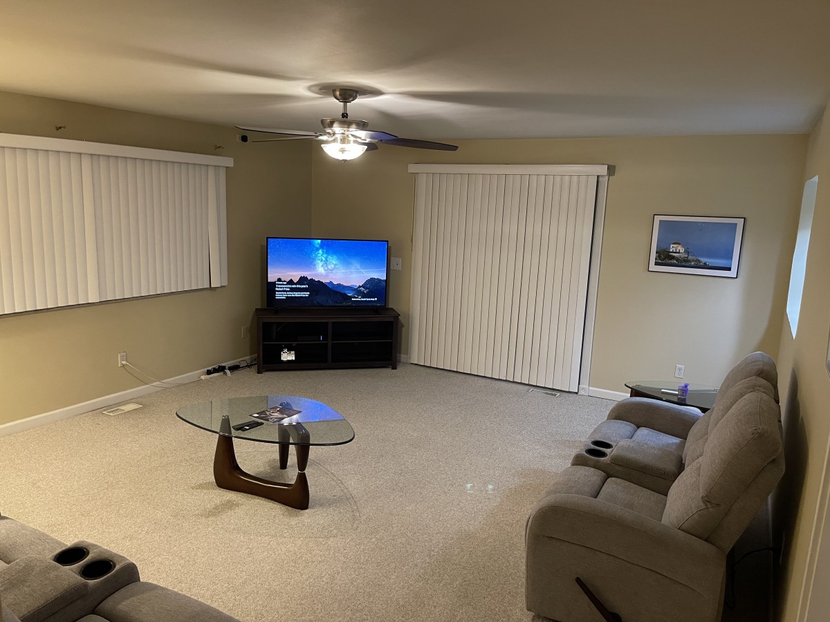 A cozy living room with a TV, sofa, and coffee table.