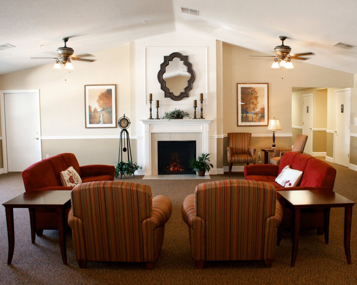 A cozy living room with a fireplace and arranged seating.