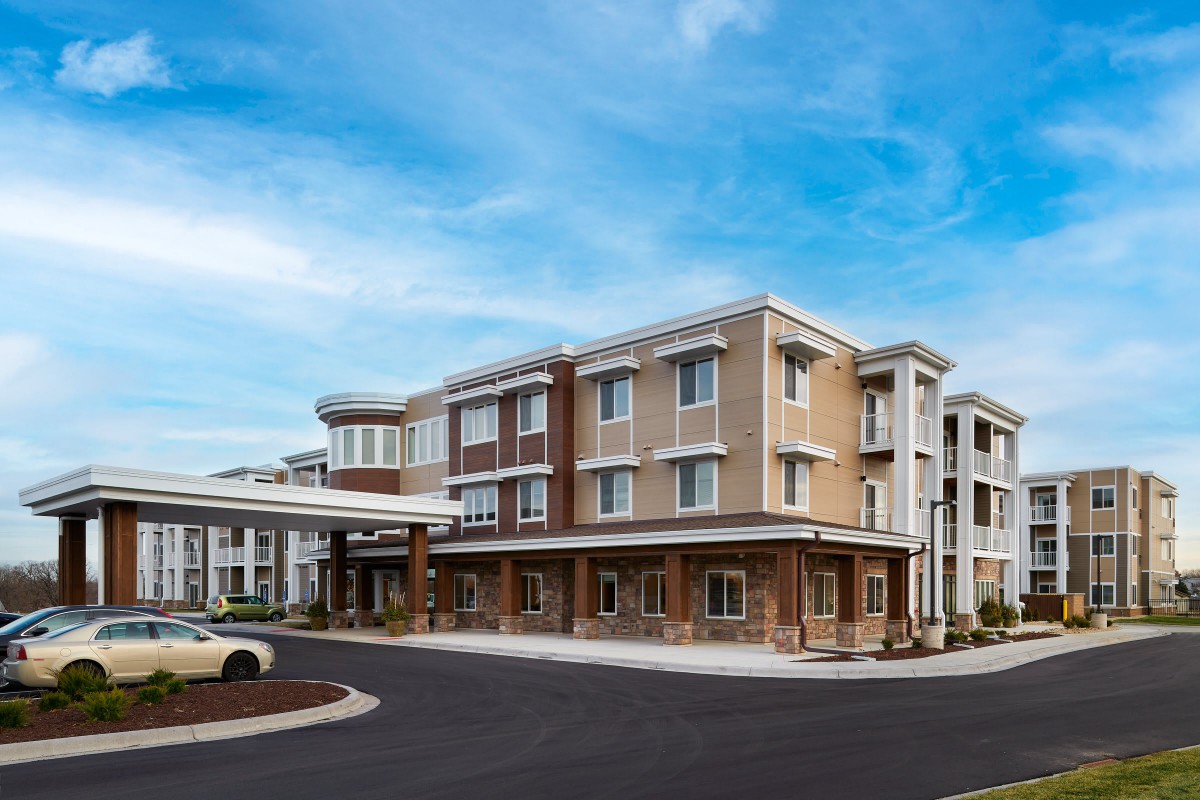 A modern hotel building with a clear blue sky in the background.