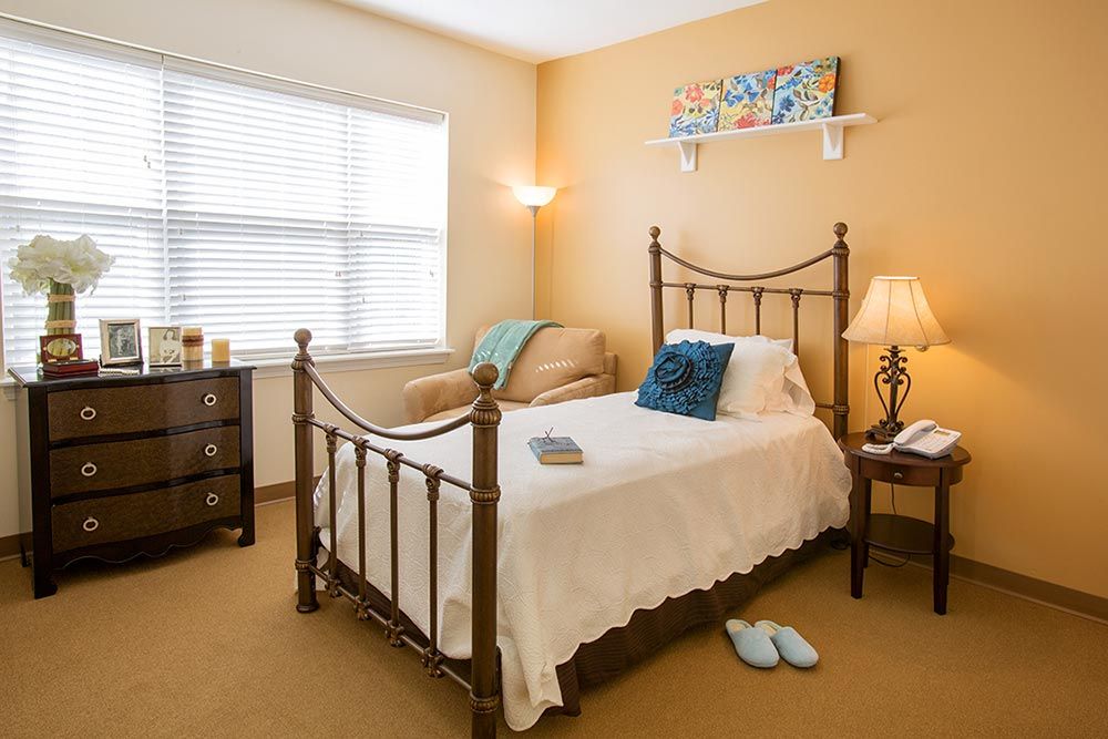 A cozy bedroom with a single bed, soft lighting, and warm decor.