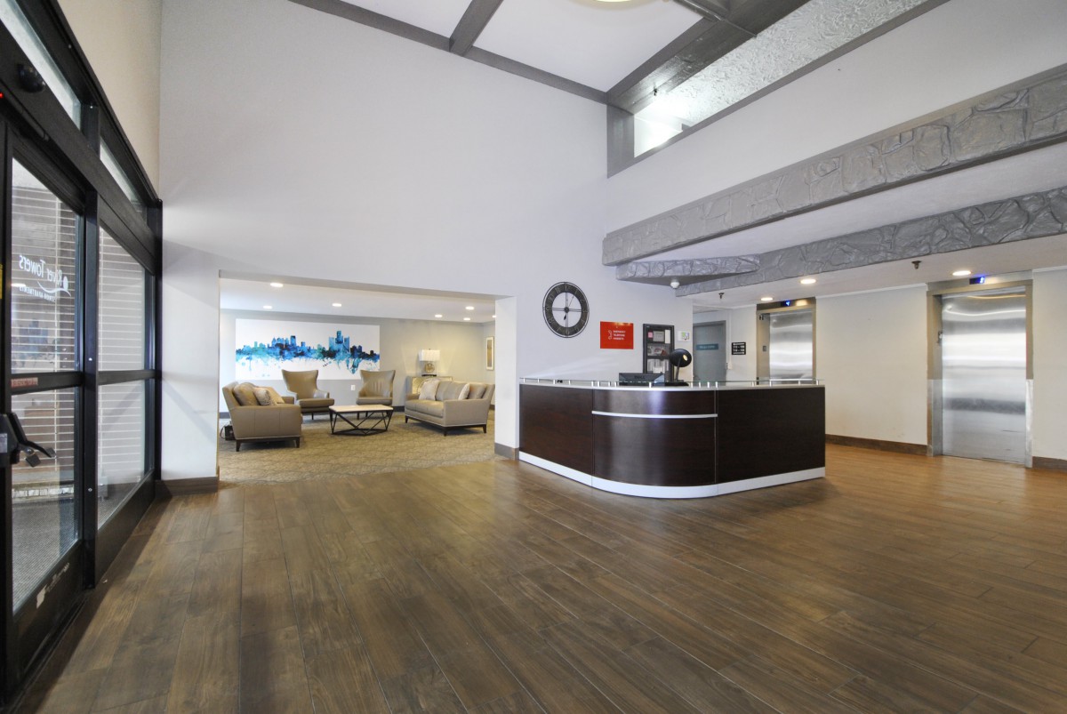 Modern office lobby with a reception desk and waiting area.