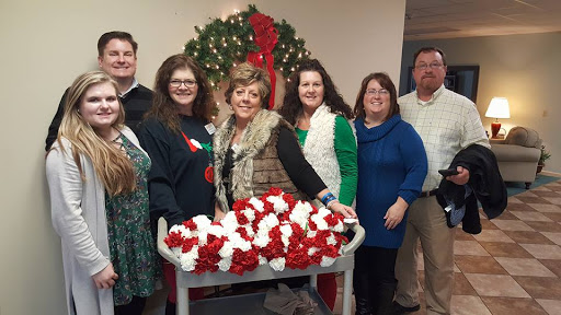 A cheerful group celebrating the holiday season with festive decorations and warm smiles.