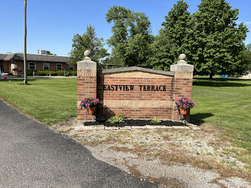 The welcoming entrance to Hastings Terrace, surrounded by lush greenery and decorative flowers.