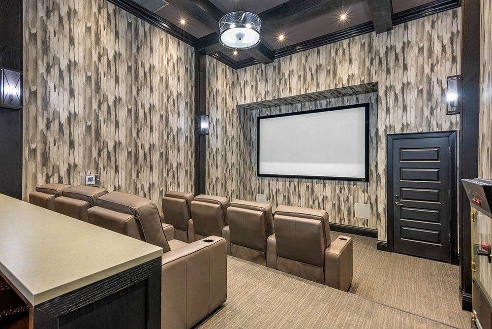 A luxurious home theater with comfortable seating and a large projector screen.