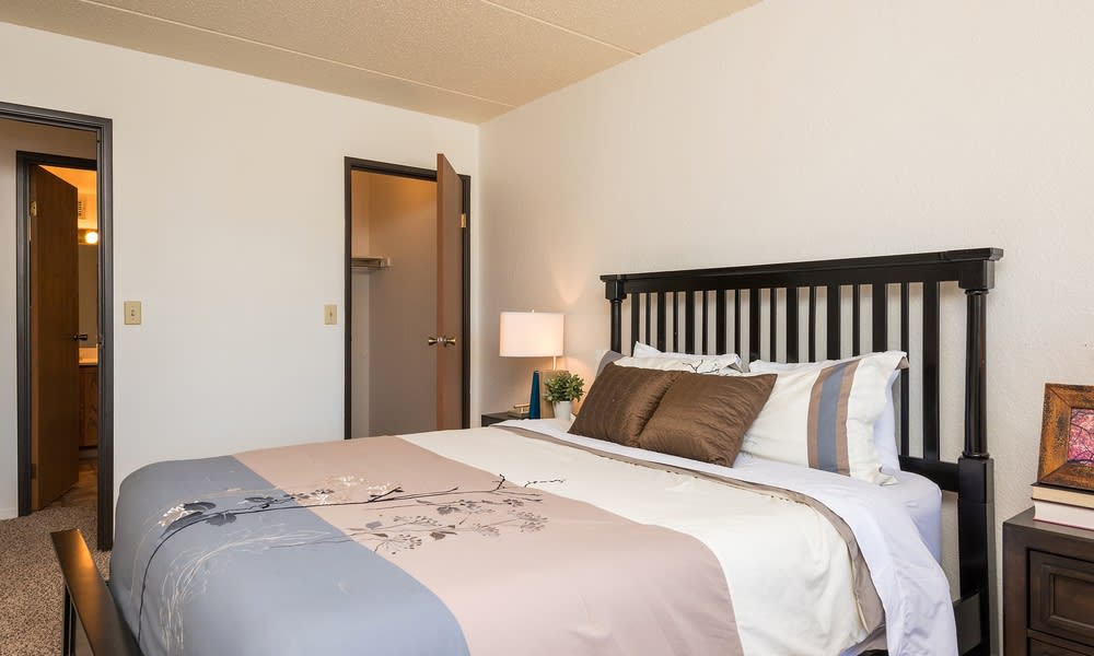A cozy bedroom with a neatly made bed and soft lighting.