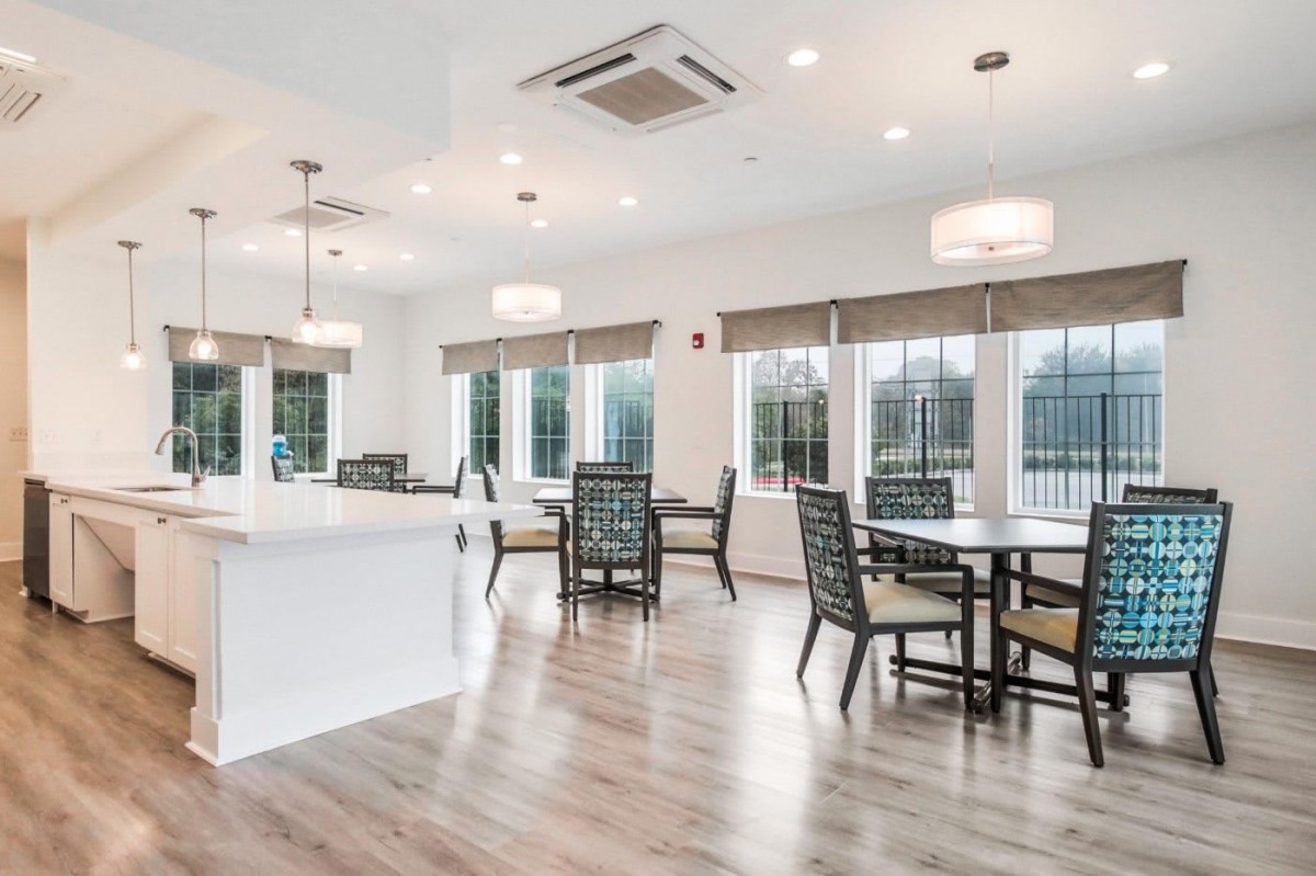 A modern open dining area with ample natural light and contemporary furniture.