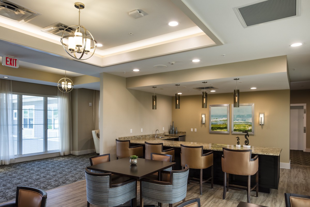 A modern dining area featuring elegant chandeliers and cozy seating arrangements.