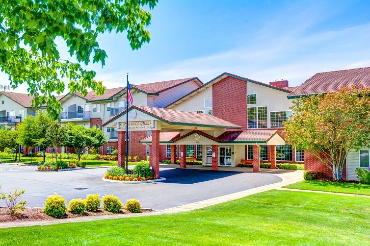 A beautiful building with well-maintained landscaping and a welcoming entrance on a sunny day.