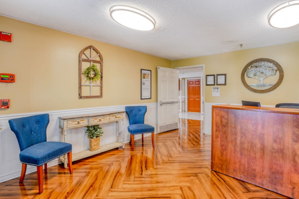 A cozy reception area with modern decor and wooden flooring.