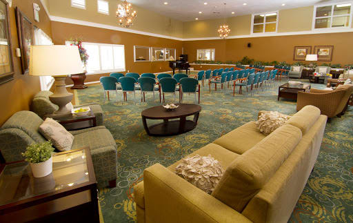 A spacious lobby area with seating arrangements and chandeliers.