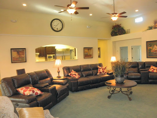 A cozy living room featuring leather sofas, stylish decor, and soft lighting.