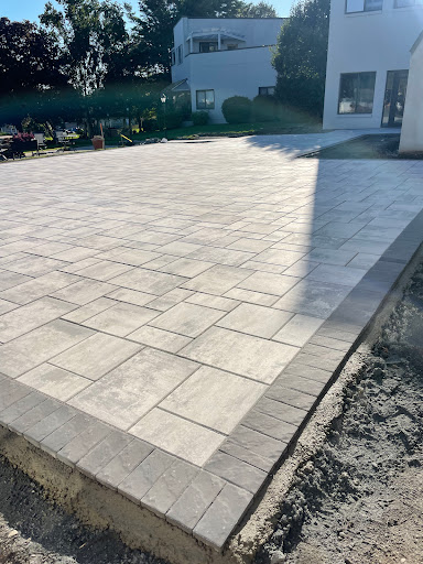 A newly paved outdoor patio with a patterned concrete surface.