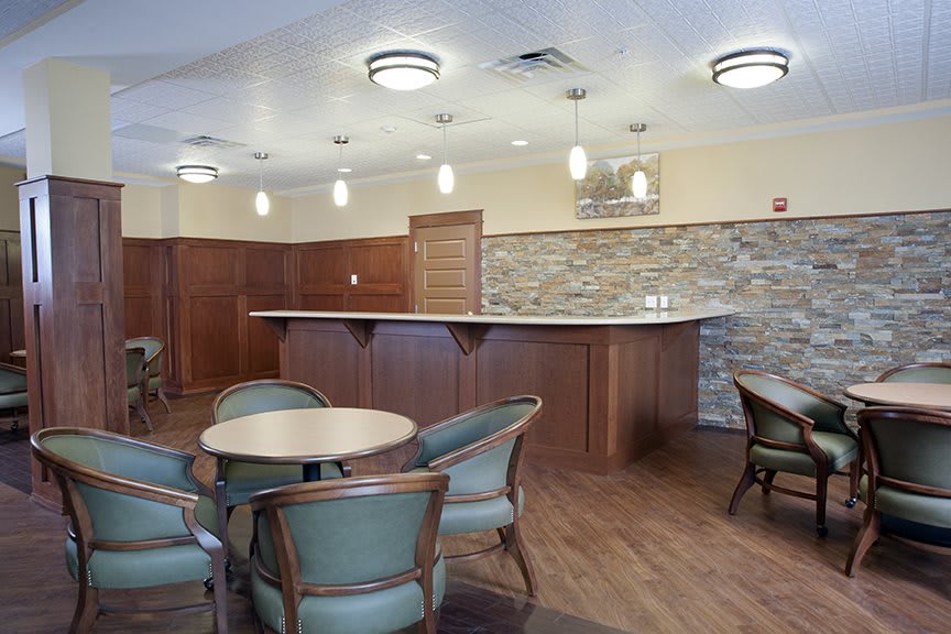 A modern lounge area with a bar counter and seating arrangements.