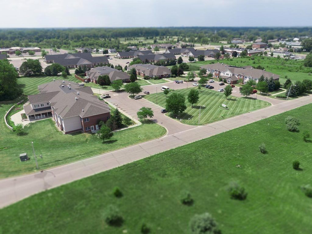 Aerial view of a suburban residential area with houses and greenery.
