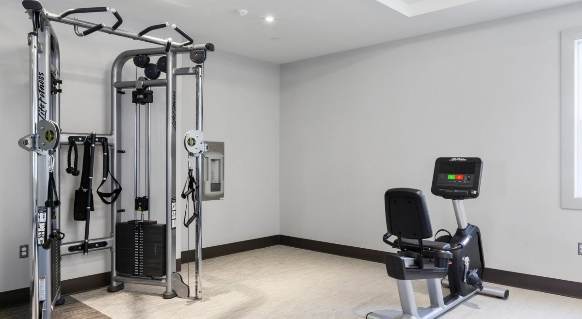 A well-equipped gym space with various exercise machines for fitness enthusiasts.