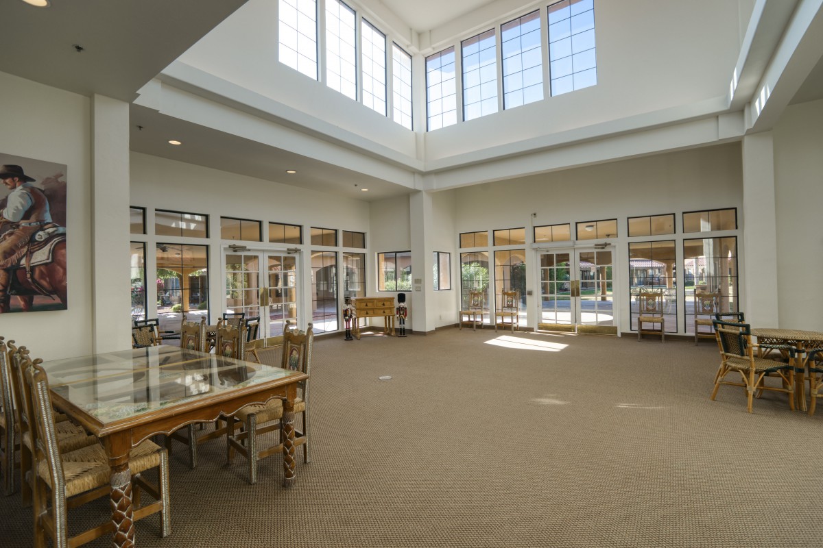 Spacious library interior with large windows and natural light.