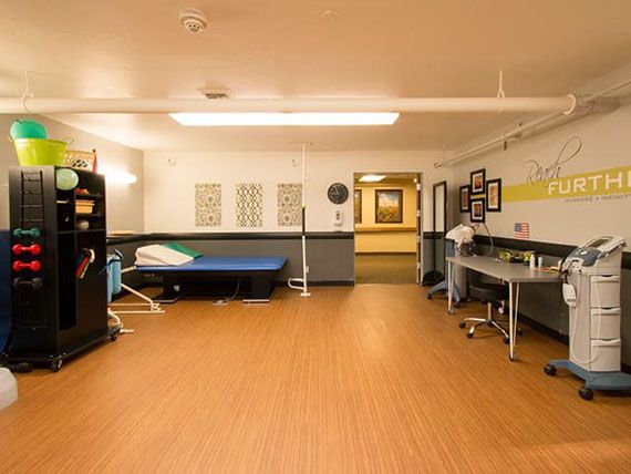 An empty medical therapy room with equipment and a clean, organized interior.
