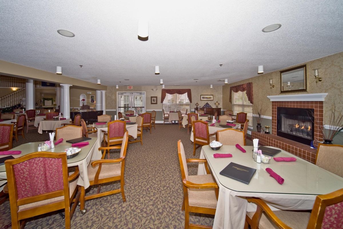 A spacious and elegantly decorated dining area with neatly arranged tables and chairs.