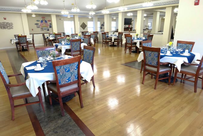 An elegant dining area with neatly arranged tables and chairs.