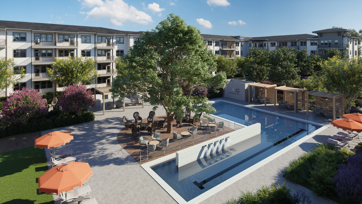 A modern apartment complex with a landscaped courtyard featuring a fountain and outdoor seating.