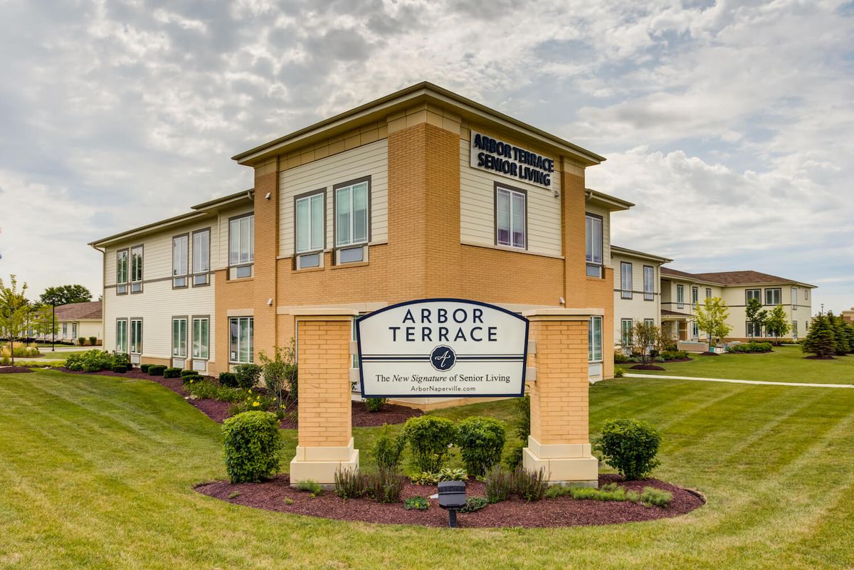A senior living facility with well-maintained landscaping under a cloudy sky.