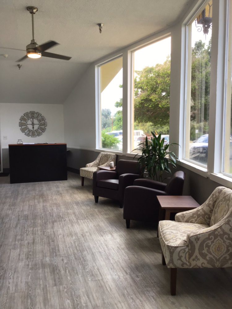 A cozy lobby area with comfortable seating and large windows.