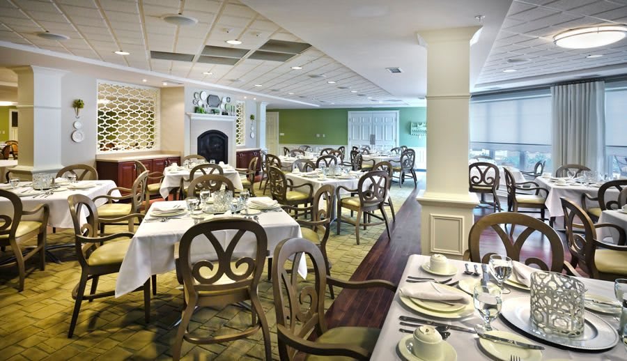 An elegant restaurant dining room with neatly arranged tables and chairs.