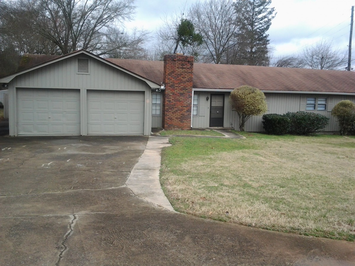 A suburban house with a two-car garage and a front lawn.