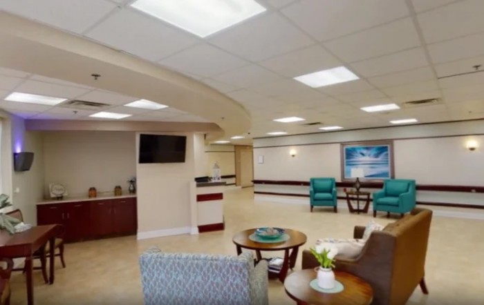 A spacious and well-lit hospital waiting room with comfortable seating and modern decor.