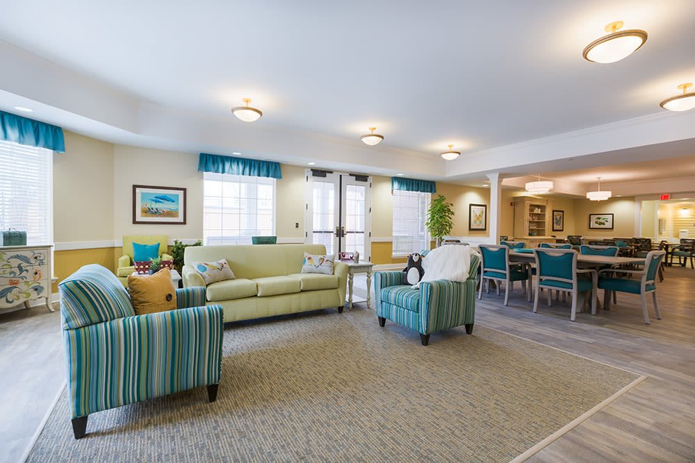A brightly lit living room with comfortable seating and tasteful decorations.