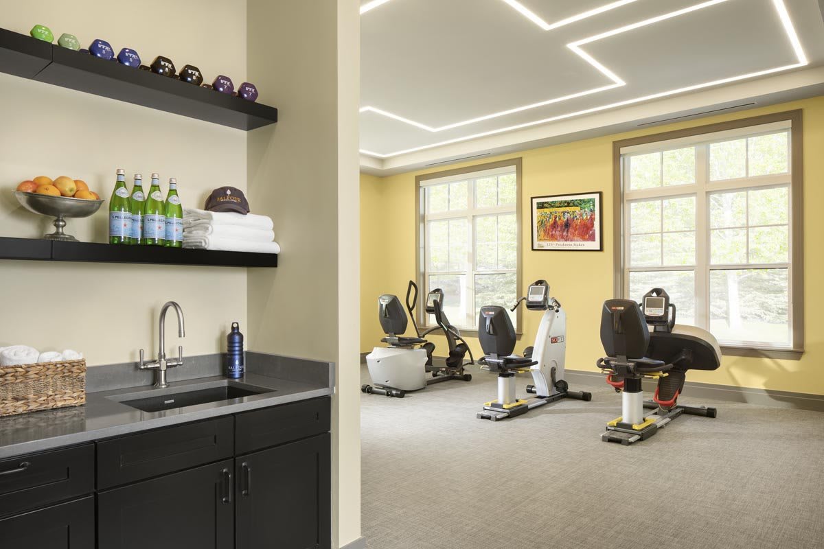 A modern fitness center featuring stationary bikes and treadmills with a sleek interior design.