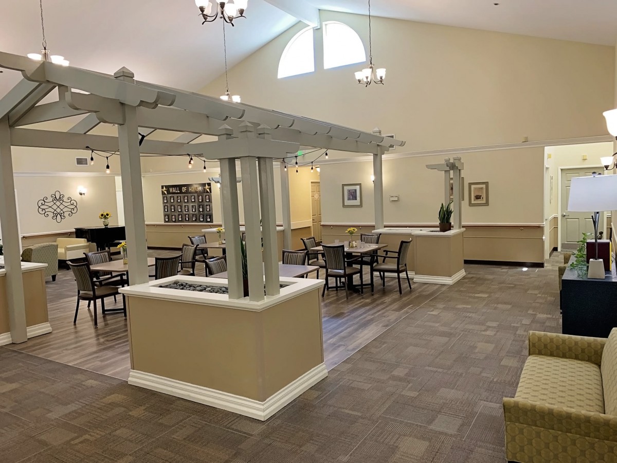 A spacious dining area with tables and chairs, featuring elegant decor and lighting.