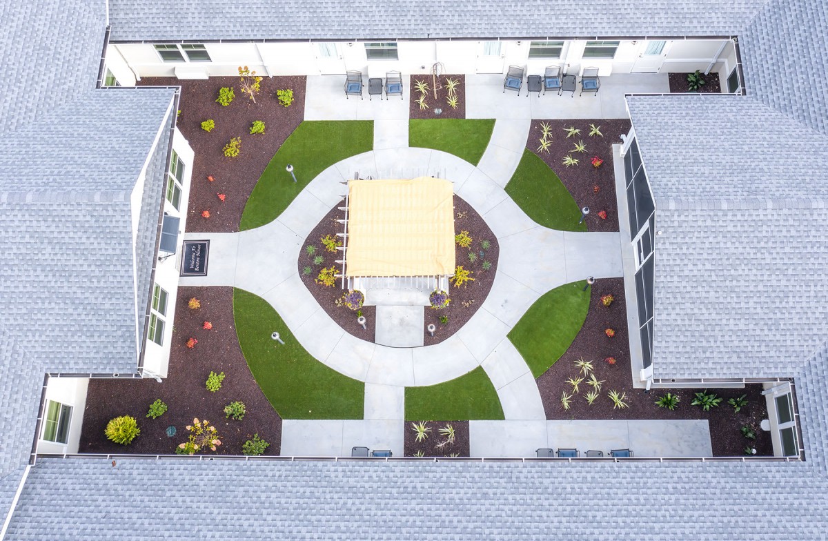 Aerial view of a symmetrically designed courtyard with pathways and garden areas.