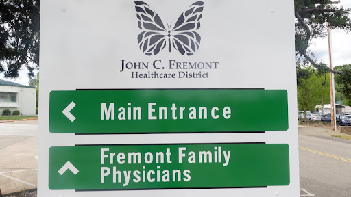 Signage indicating the main entrance and family physicians at John C. Fremont Healthcare District.