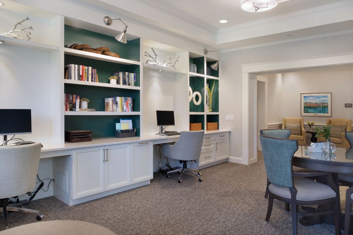 A modern home office with built-in shelves and a workspace.
