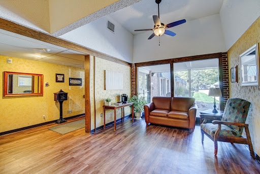 A bright and inviting living room featuring comfortable seating and ample natural light.