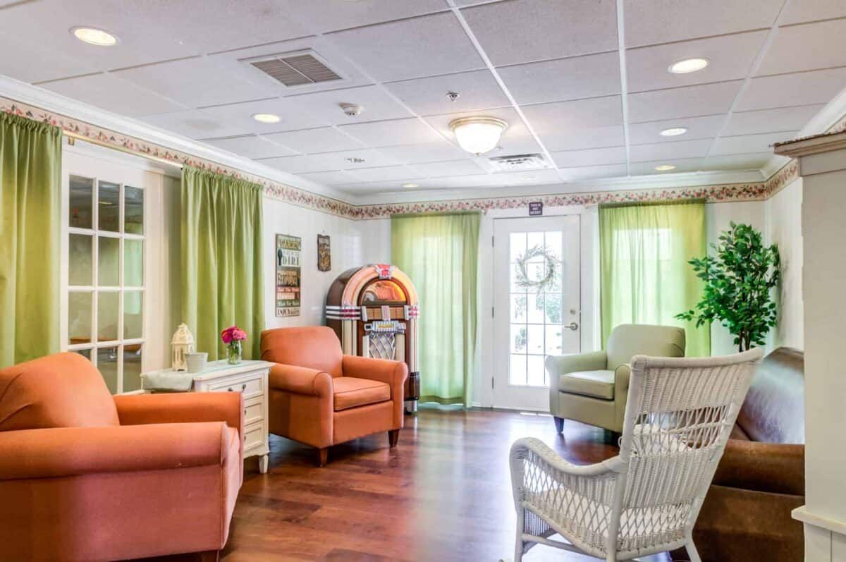 A cozy living area with colorful chairs and natural lighting.