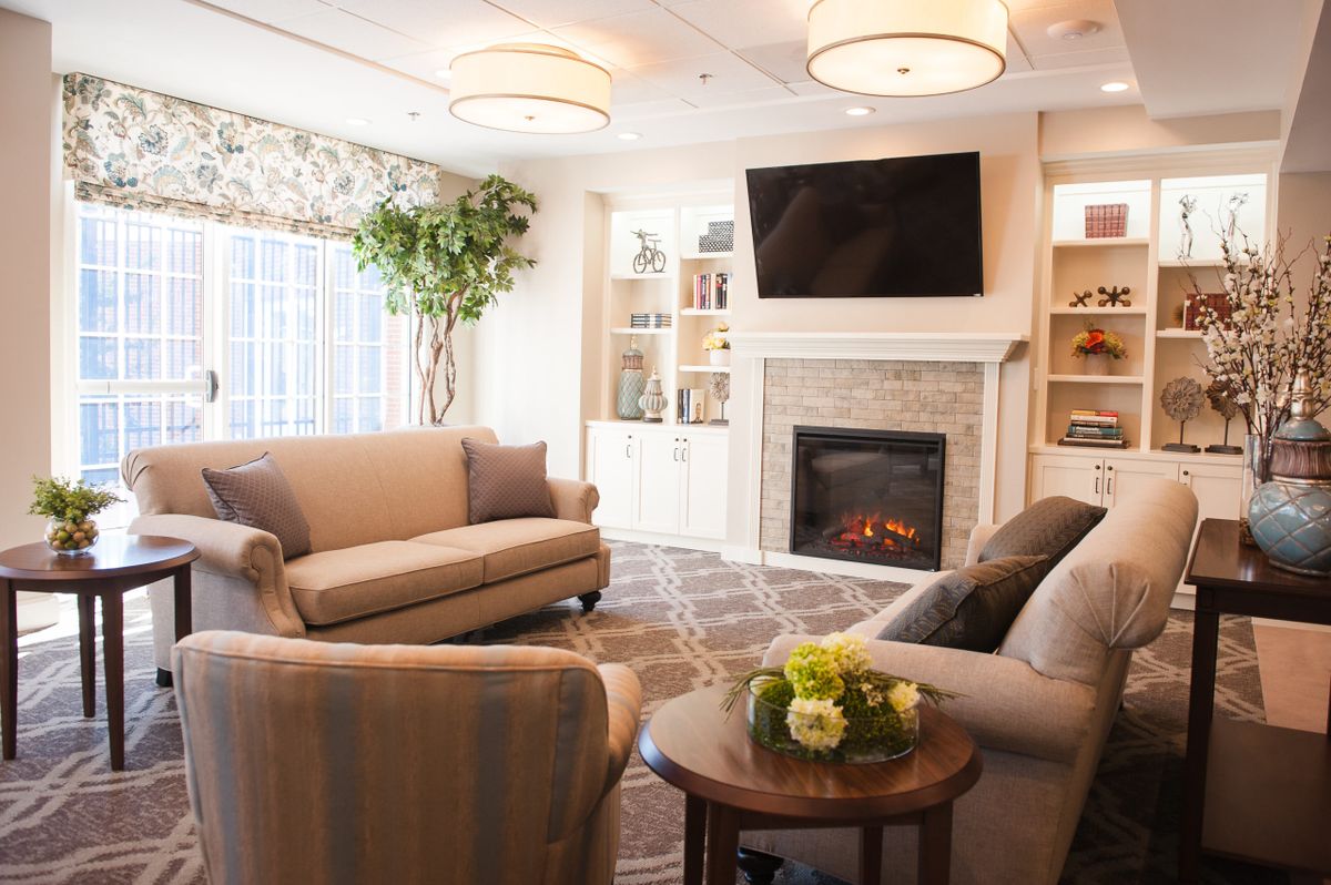 A cozy and modern living room featuring a fireplace and comfortable seating.
