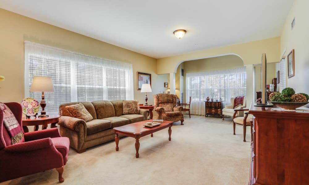 A cozy living room with comfortable seating and large windows.