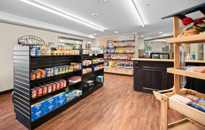 A well-organized store with shelves stocked with various grocery products.