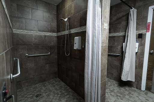 A modern shower area with tiled walls and a clean design.