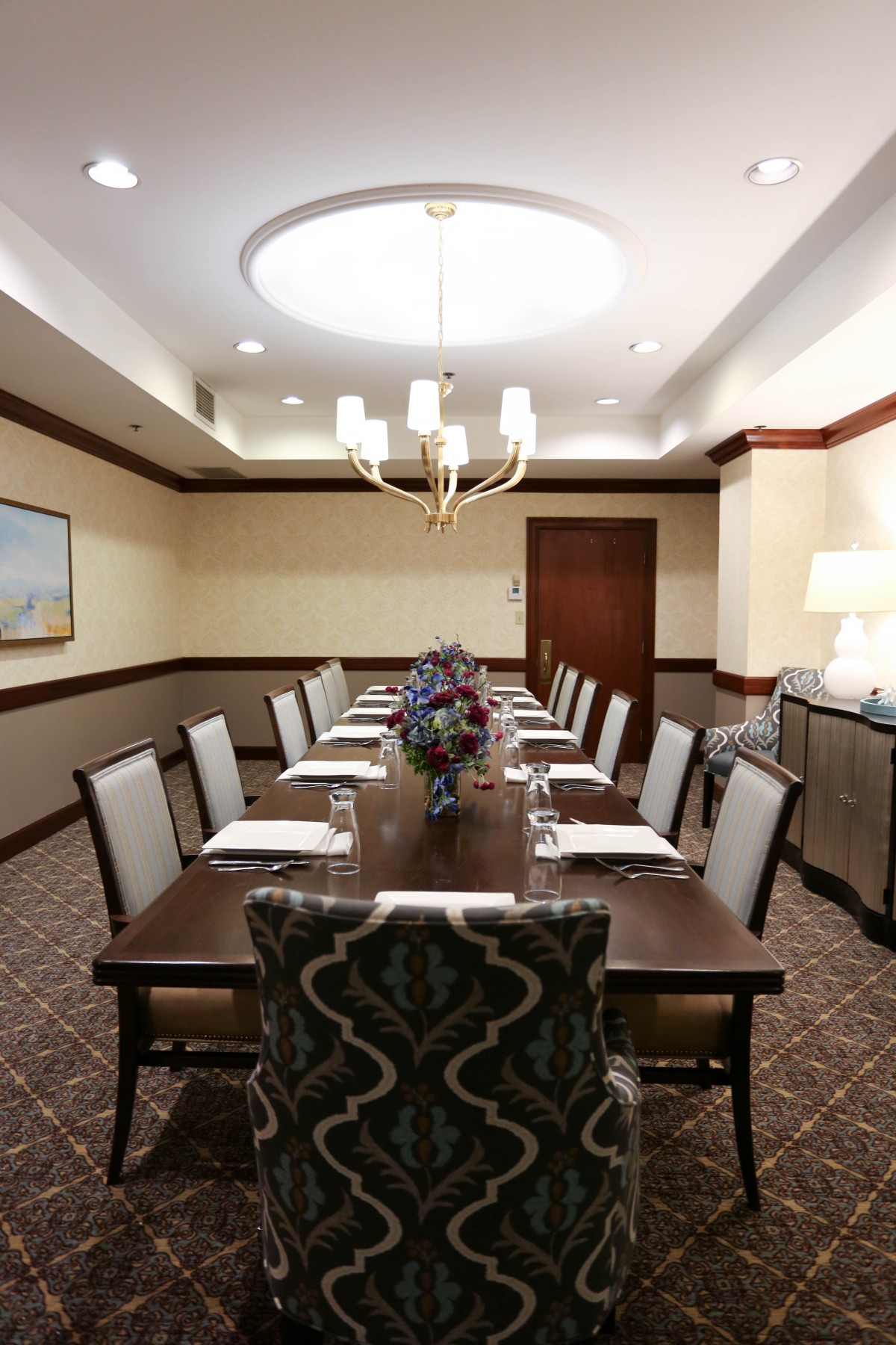 A well-appointed conference room with a long table and chairs arranged for a meeting.