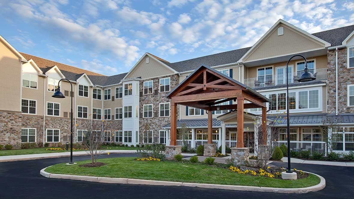 A modern residential building with an inviting entrance and well-maintained landscaping.