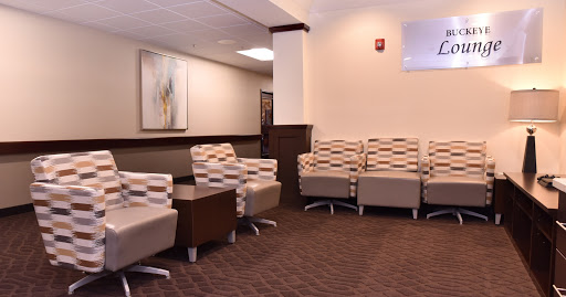 A modern waiting room featuring comfortable seating and a minimalistic design.