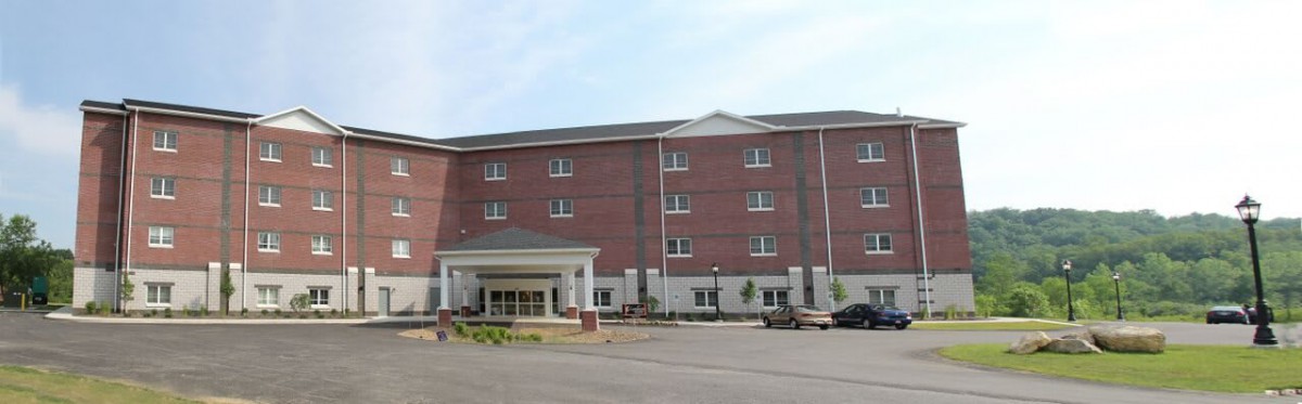 A large brick hotel building with multiple windows and an entrance canopy.