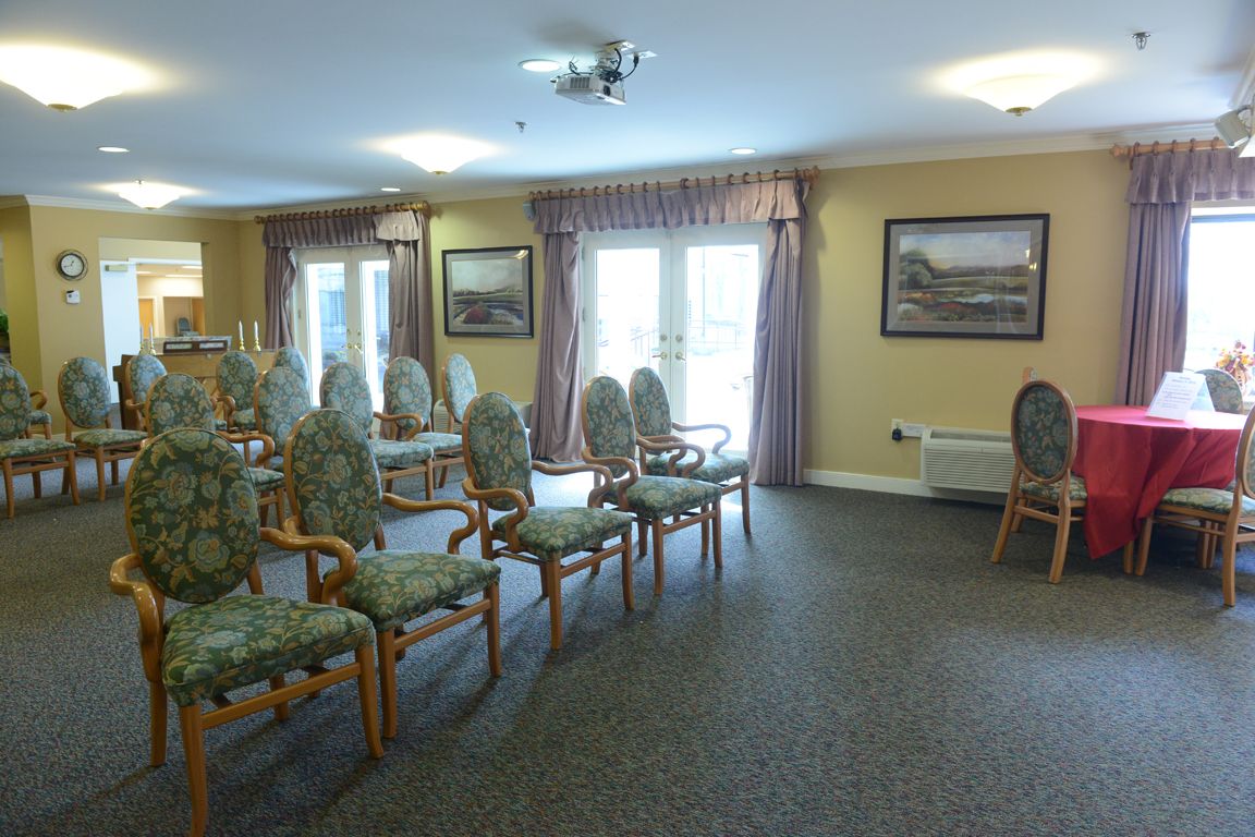 A well-lit meeting room with arranged chairs and decor.
