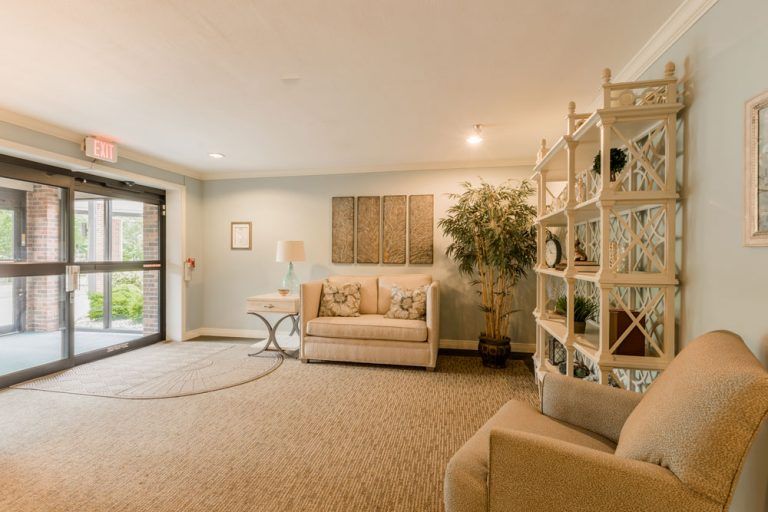 A cozy and modern living room featuring a comfortable sofa, stylish shelving unit, and decorative wall art.